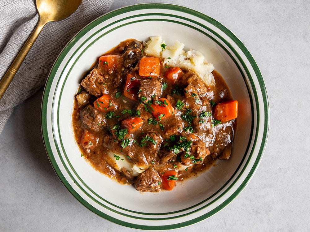 Sous vide beef bourguignon with slow-cooked beef, red wine sauce, bacon, mushrooms, and herbs.