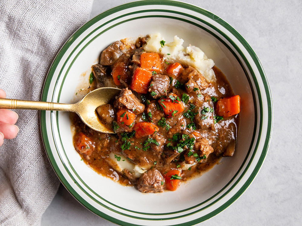 Sous vide beef bourguignon with slow-cooked beef, red wine sauce, bacon, mushrooms, and herbs.