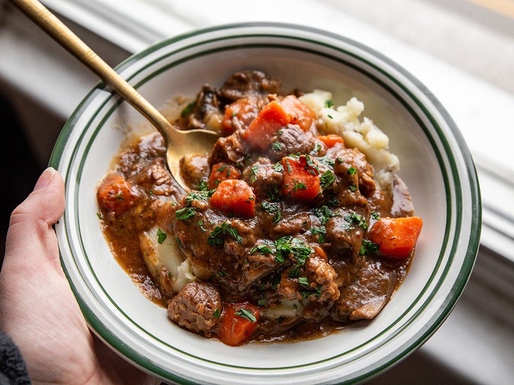 Sous vide beef bourguignon with slow-cooked beef, red wine sauce, bacon, mushrooms, and herbs.